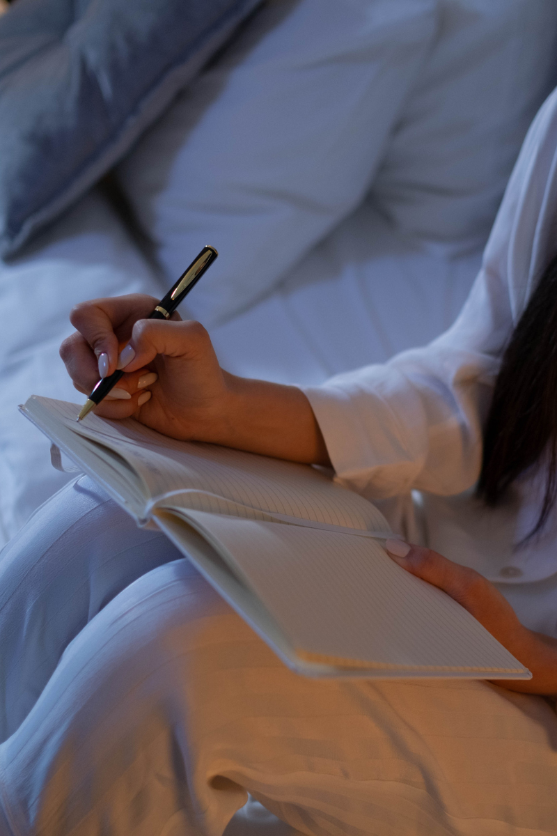 Person writing ideas in a notebook